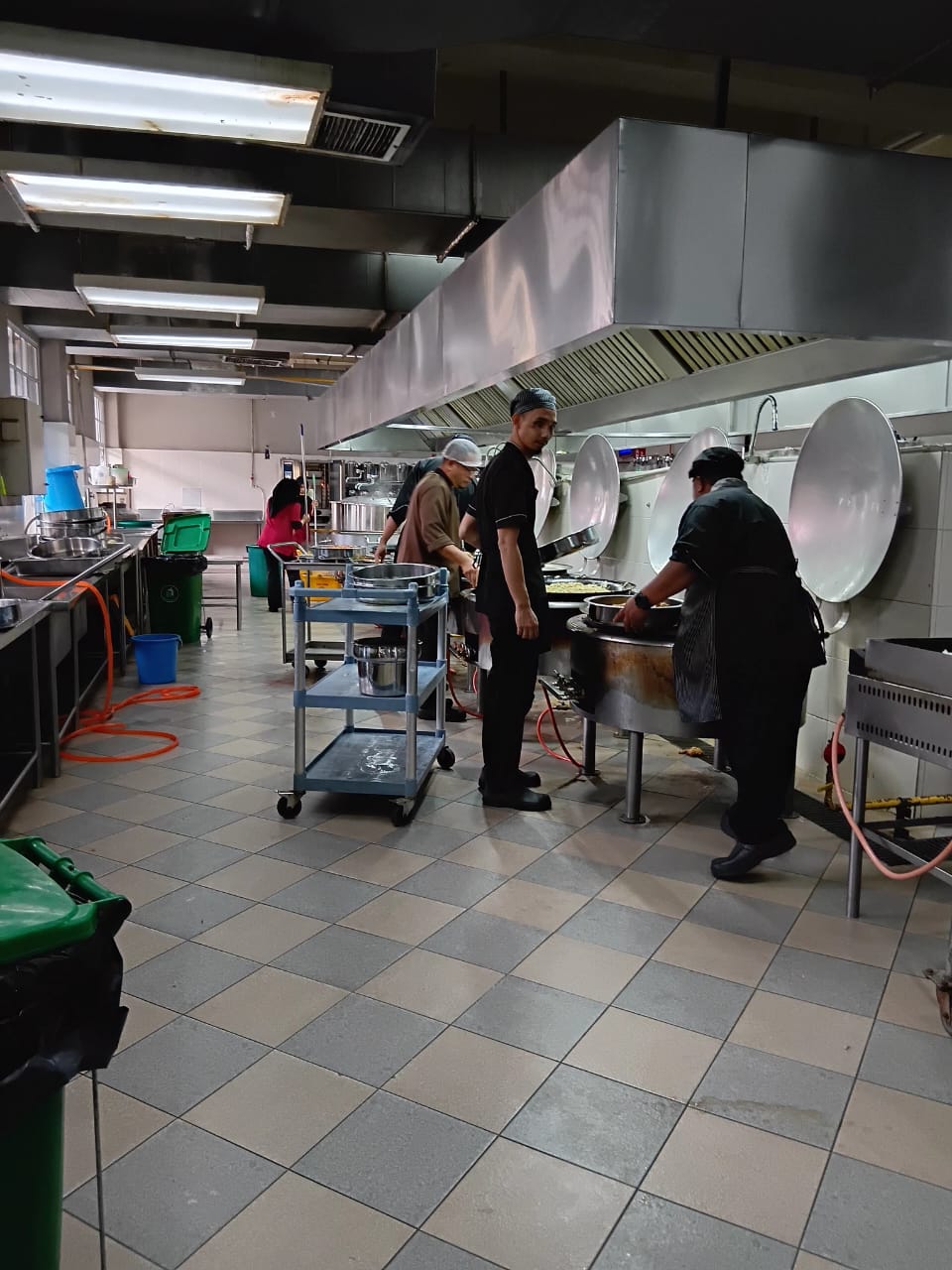 Center kitchen team preparing food trays